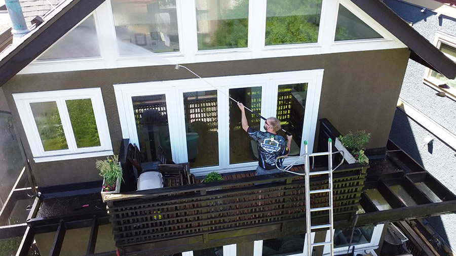 a clean squad employee soft washing home siding