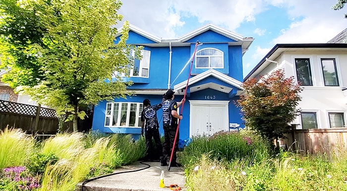 clean squad property services team member soft washing siding home