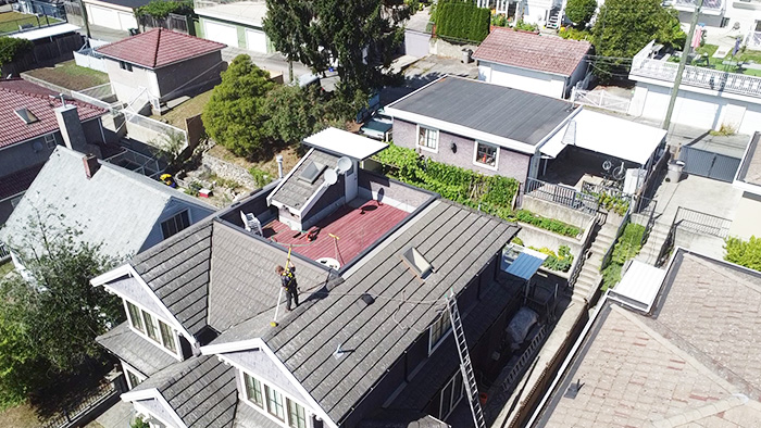 clean squad property services team member cleaning roof