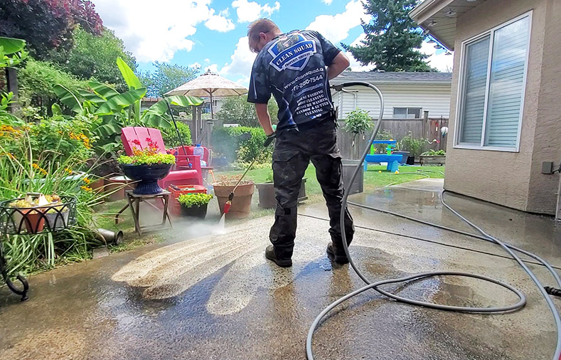 team member pressure washing concrete in richmond bc
